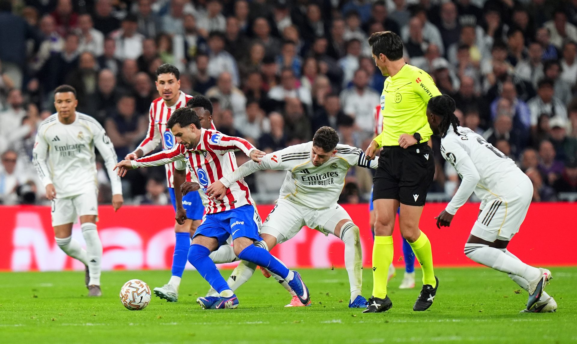 Alex Baena of Atletico Madrid and Federico Valverde of Real Madrid